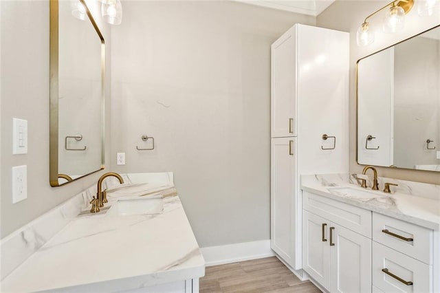 full bathroom featuring baseboards, wood finished floors, and vanity