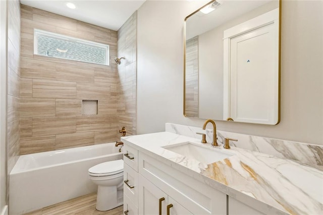 bathroom featuring wood finished floors, shower / bathtub combination, vanity, and toilet