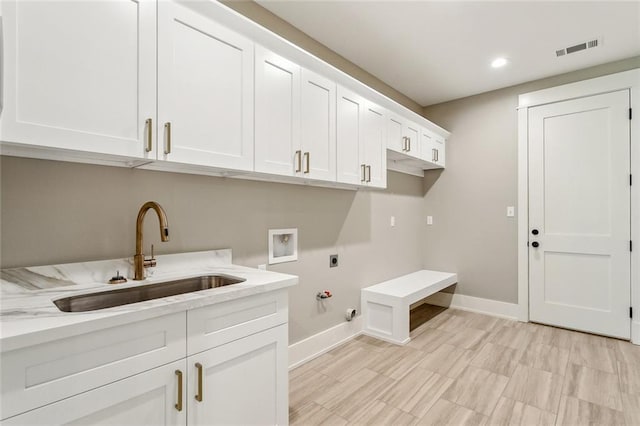 laundry area with a sink, hookup for an electric dryer, visible vents, baseboards, and hookup for a gas dryer