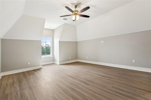 bonus room with wood finished floors, visible vents, baseboards, and ceiling fan