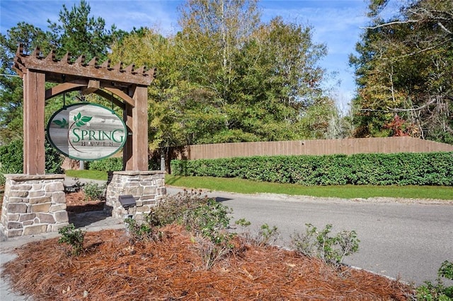 community sign featuring fence