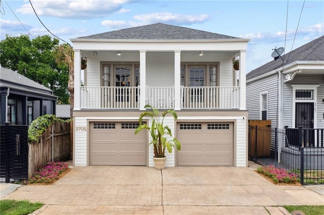 370507 Laurel St, New Orleans, LA 70115 - view of front of home featuring a garage, driveway, fence, and roof with shingles