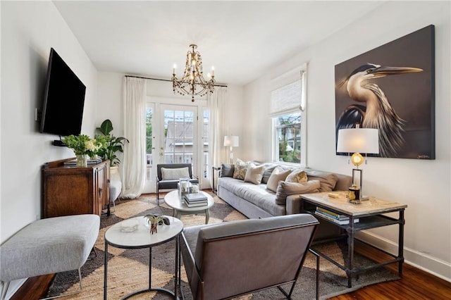 370507 Laurel St, New Orleans, LA 70115 - living room featuring baseboards, a healthy amount of sunlight, a chandelier, and wood finished floors