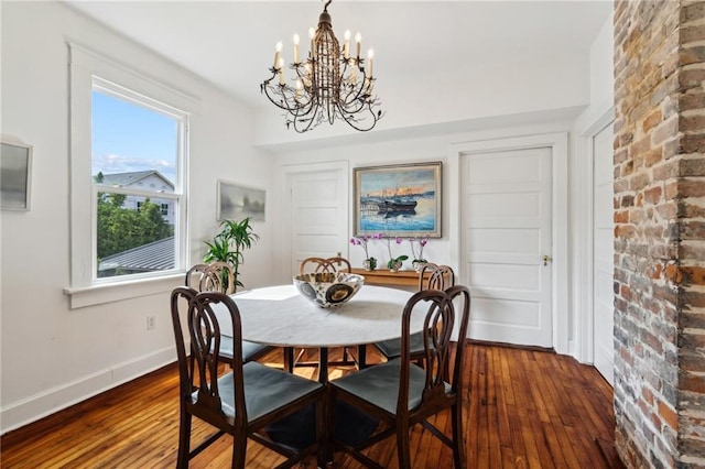 370507 Laurel St, New Orleans, LA 70115 - dining room with dark wood-style floors, a healthy amount of sunlight, baseboards, and an inviting chandelier