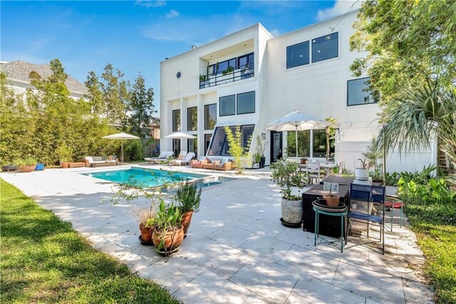 4809 Neyrey Dr, Metairie, LA 70002 - rear view of house featuring a patio area, stucco siding, and an outdoor pool