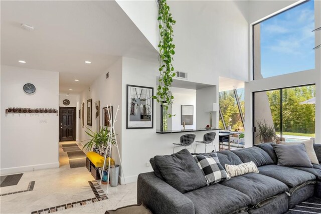 4809 Neyrey Dr, Metairie, LA 70002 - living area featuring recessed lighting, inlaid floor details, and a towering ceiling