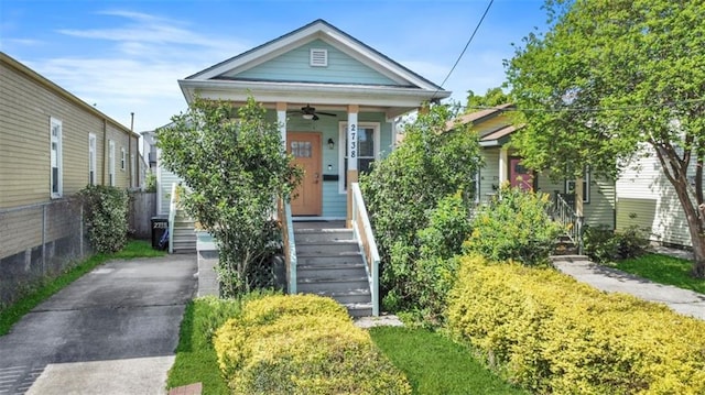 2738 Cleveland Ave, New Orleans, LA 70119 - shotgun-style home featuring stairway, driveway, ceiling fan, and covered porch
