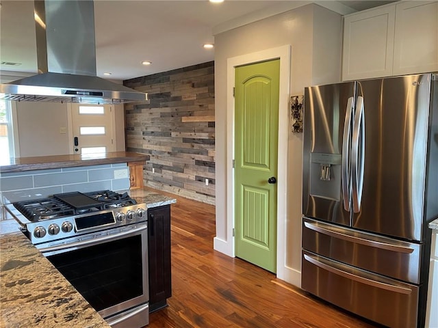 kitchen with white cabinets, stainless steel appliances, dark wood finished floors, recessed lighting, and island range hood