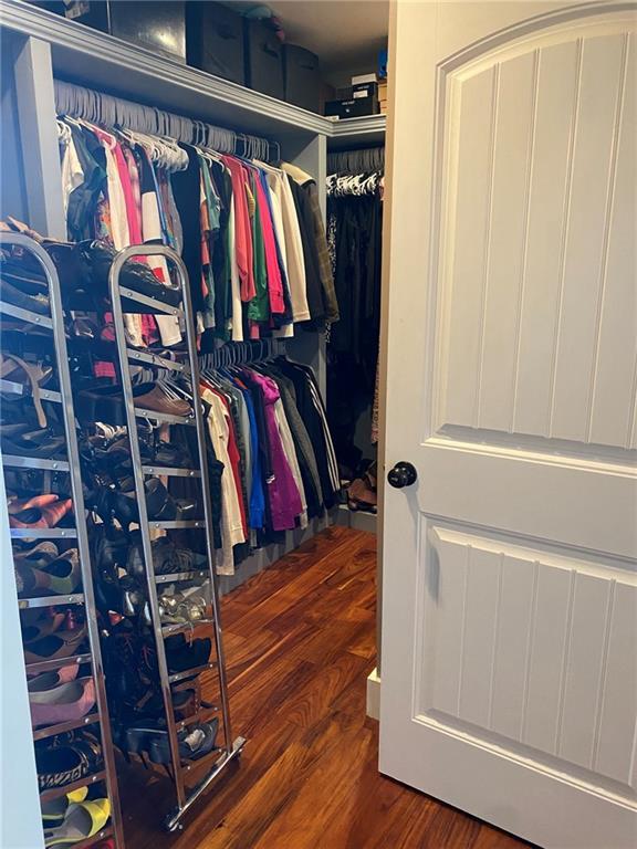 spacious closet with wood finished floors