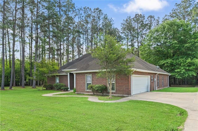 view of front of home featuring brick siding, an attached garage, driveway, and a front lawn