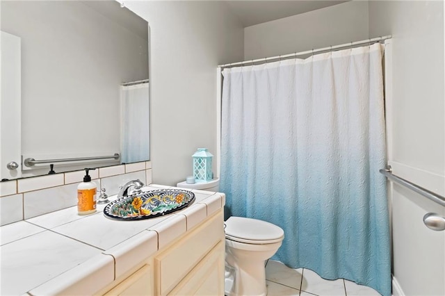 bathroom featuring vanity, backsplash, toilet, and a shower with curtain