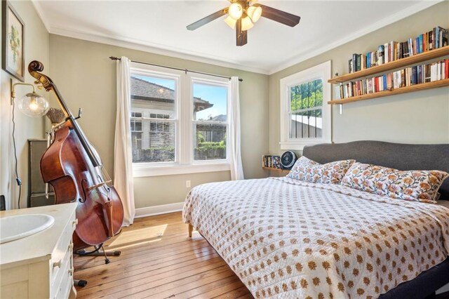 517 S Murat St, New Orleans, LA 70119 - bedroom featuring light wood-style flooring, crown molding, and ceiling fan