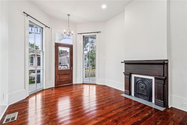 2642-4444 Lepage St, New Orleans, LA 70119 - entryway featuring a chandelier, wood finished floors, and a fireplace with flush hearth