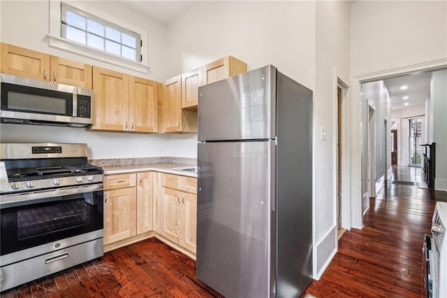 2642-4444 Lepage St, New Orleans, LA 70119 - kitchen featuring appliances with stainless steel finishes, light brown cabinets, a towering ceiling, light countertops, and dark wood-type flooring