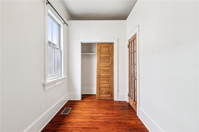 2642-4444 Lepage St, New Orleans, LA 70119 - unfurnished bedroom with dark wood-style floors, a closet, and crown molding
