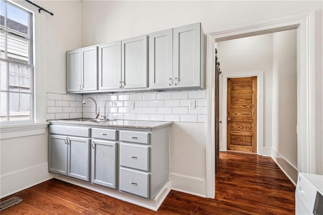 2642-4444 Lepage St, New Orleans, LA 70119 - kitchen featuring gray cabinetry, backsplash, and dark wood finished floors