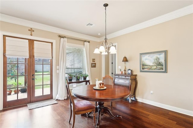 dining area featuring french doors, a wealth of natural light, visible vents, a chandelier, and wood finished floors
