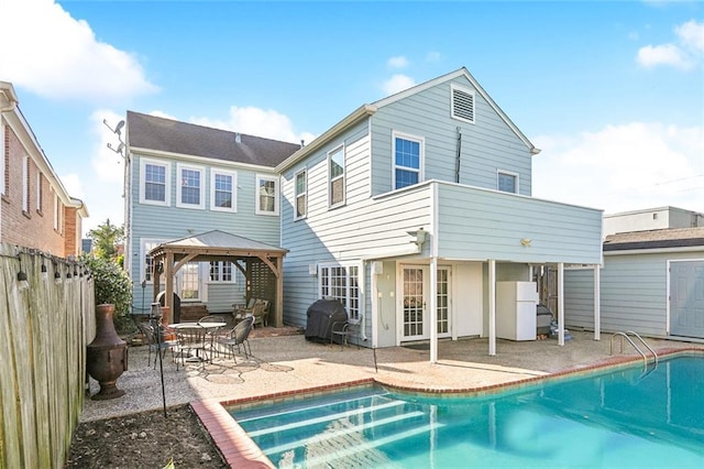 3439 Octavia St, New Orleans, LA 70125 - rear view of house featuring a gazebo, a patio, a fenced in pool, and fence