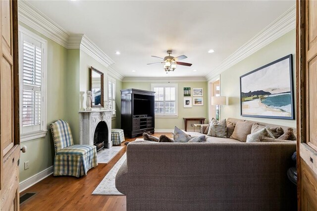3439 Octavia St, New Orleans, LA 70125 - living area featuring a fireplace with flush hearth, dark wood-type flooring, baseboards, visible vents, and ceiling fan
