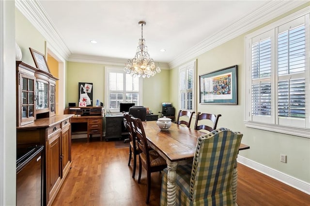 3439 Octavia St, New Orleans, LA 70125 - dining area with crown molding, wood finished floors, baseboards, and a notable chandelier