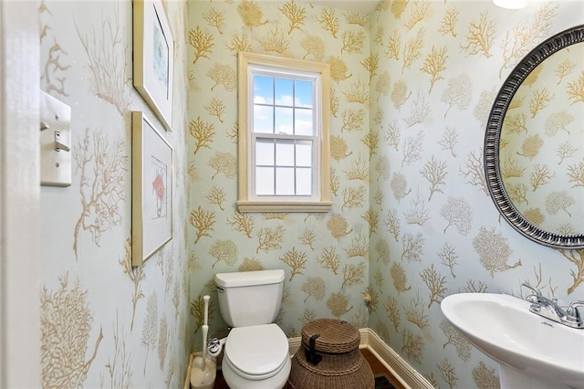 3439 Octavia St, New Orleans, LA 70125 - half bathroom with toilet, baseboards, and a sink