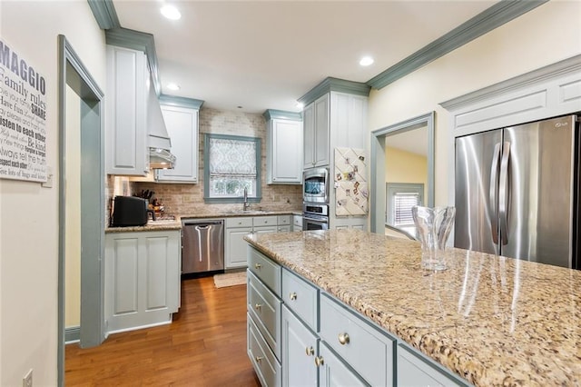 3439 Octavia St, New Orleans, LA 70125 - kitchen featuring stainless steel appliances, a sink, tasteful backsplash, wood finished floors, and light stone countertops