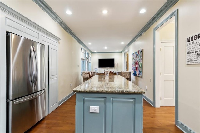 3439 Octavia St, New Orleans, LA 70125 - kitchen with freestanding refrigerator, dark wood finished floors, crown molding, and a center island
