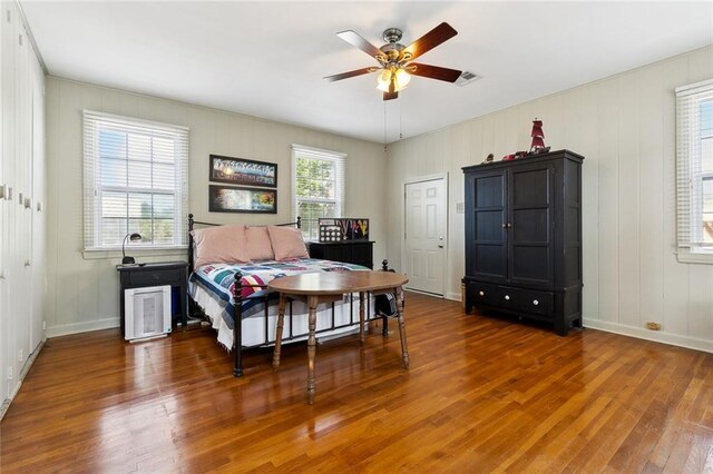 3439 Octavia St, New Orleans, LA 70125 - bedroom with baseboards, a decorative wall, visible vents, and wood finished floors