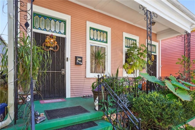 view of exterior entry with covered porch