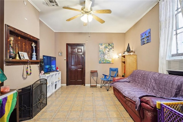 living room featuring visible vents, crown molding, baseboards, and a ceiling fan