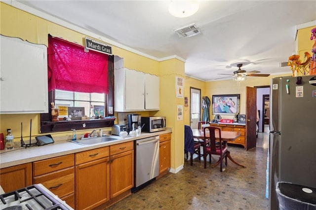 kitchen featuring a sink, visible vents, dark floors, light countertops, and appliances with stainless steel finishes