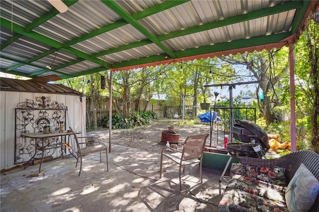 view of patio featuring a fenced backyard, an outdoor structure, and a shed