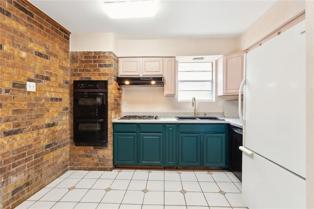 kitchen featuring under cabinet range hood, light countertops, a sink, black appliances, and brick wall