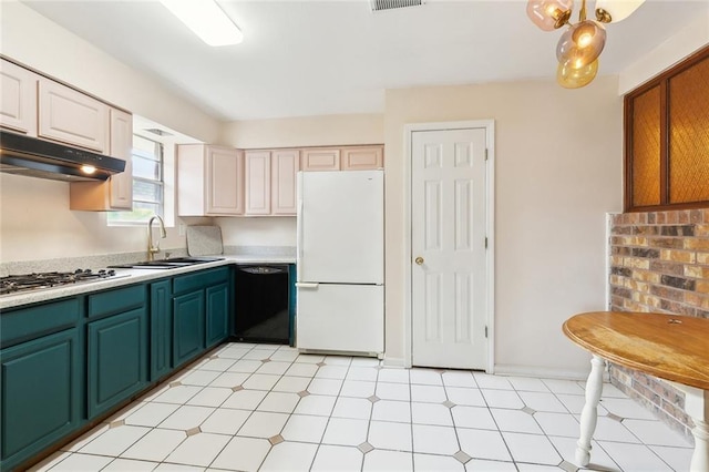 kitchen featuring light floors, a sink, freestanding refrigerator, stainless steel gas cooktop, and black dishwasher