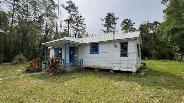 39202 Pine St, Pearl River, LA 70452 - view of front facade featuring a porch, a front yard, and metal roof