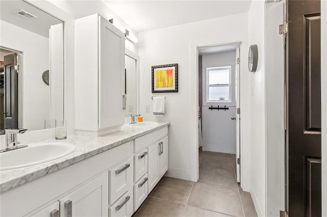 66 Carolyn Ct, Arabi, LA 70032 - bathroom featuring double vanity and tile patterned floors