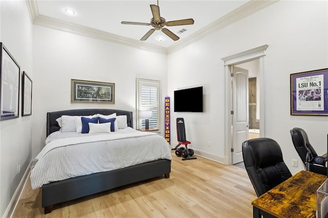 bedroom featuring baseboards, crown molding, and light wood finished floors