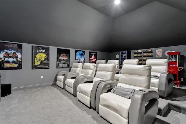 carpeted cinema with vaulted ceiling and baseboards