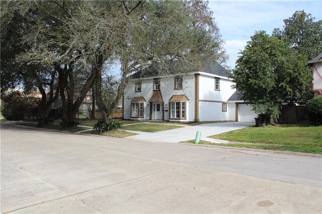 3810 Tall Pines Dr, New Orleans, LA 70131 - view of front of property with concrete driveway, a front yard, and stucco siding