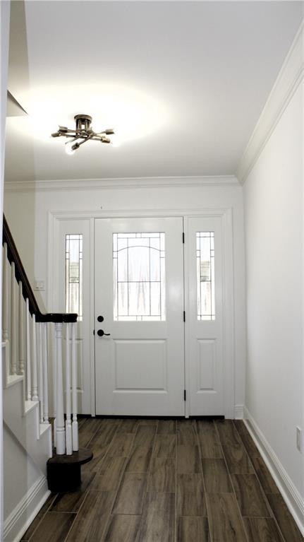 3810 Tall Pines Dr, New Orleans, LA 70131 - unfurnished living room featuring ornamental molding, a glass covered fireplace, wood finished floors, baseboards, and recessed lighting