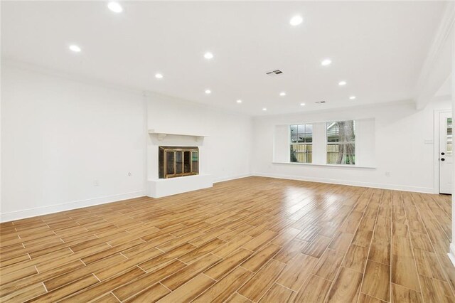 3810 Tall Pines Dr, New Orleans, LA 70131 - unfurnished living room with a glass covered fireplace, ornamental molding, baseboards, dark wood-type flooring, and recessed lighting
