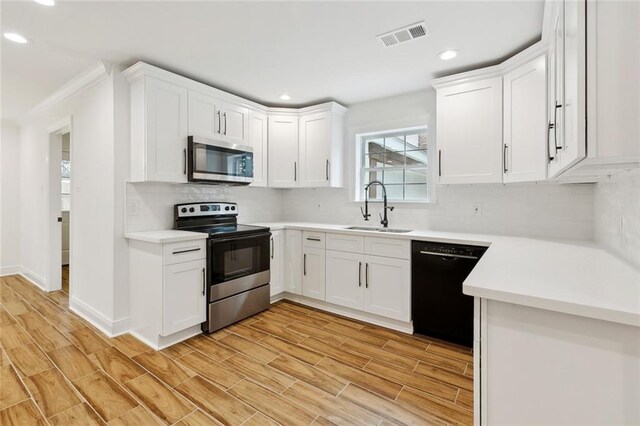 3810 Tall Pines Dr, New Orleans, LA 70131 - kitchen with a sink, black appliances, white cabinets, dark wood finished floors, and recessed lighting