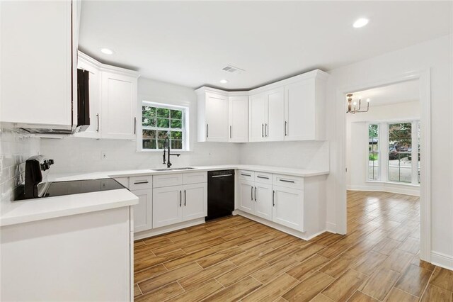 3810 Tall Pines Dr, New Orleans, LA 70131 - kitchen view of a sink, backsplash, light countertops, and black dishwasher