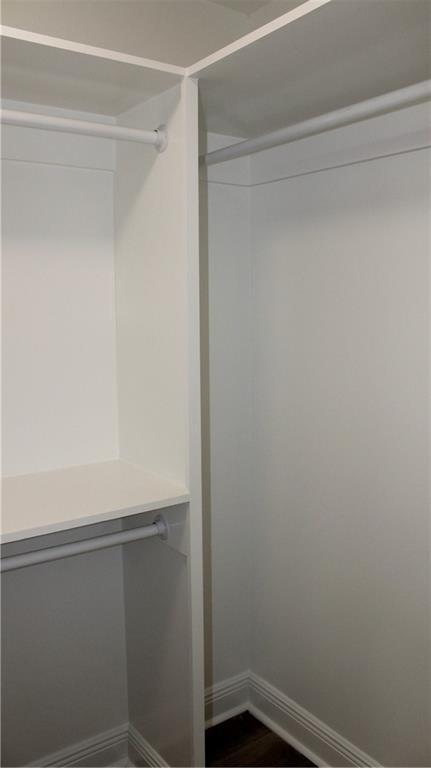 3810 Tall Pines Dr, New Orleans, LA 70131 - spacious closet featuring dark wood-style floors