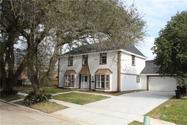 3810 Tall Pines Dr, New Orleans, LA 70131 - view of front of home featuring roof with shingles, driveway, a front lawn, stucco siding, and an attached garage