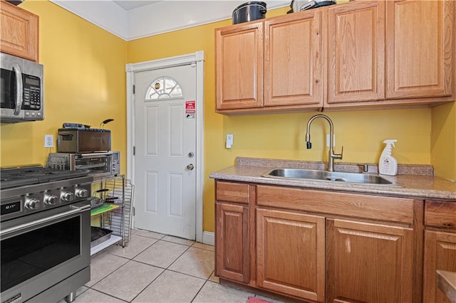 242426 Valence St, New Orleans, LA 70115 - kitchen featuring a toaster, light countertops, a sink, light tile patterned floors, and stainless steel appliances