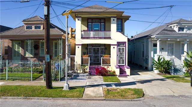 242426 Valence St, New Orleans, LA 70115 - view of front of property featuring a porch, fence, a balcony, concrete driveway, and a shingled roof