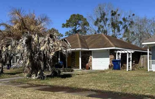 view of front facade with a front yard and a garage