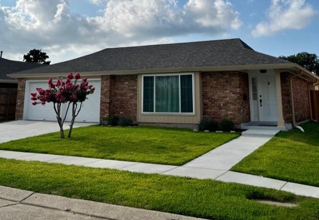 42 Boimare Ave, Kenner, LA 70065 - ranch-style house with a garage, a front lawn, driveway, and brick siding
