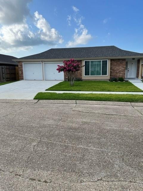 42 Boimare Ave, Kenner, LA 70065 - single story home with concrete driveway, an attached garage, and a front lawn